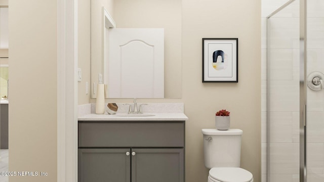 full bath featuring a tile shower, toilet, and vanity