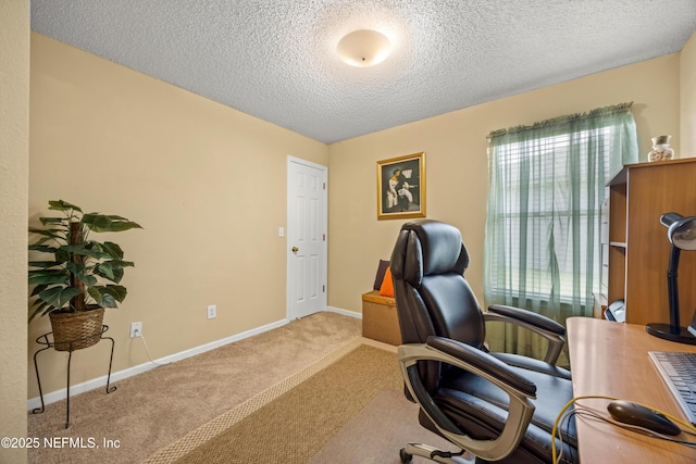 carpeted office space with a textured ceiling and baseboards