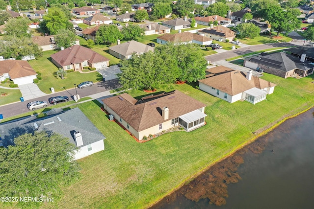 drone / aerial view with a residential view and a water view