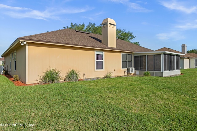 back of property featuring a sunroom, a shingled roof, central AC unit, a lawn, and a chimney
