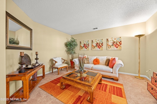 carpeted living room with a textured ceiling, visible vents, and baseboards