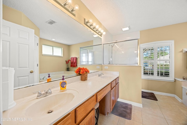 full bathroom featuring a sink, double vanity, visible vents, and tile patterned flooring