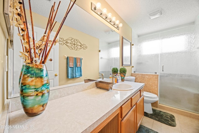 bathroom featuring toilet, a textured ceiling, a shower stall, and tile patterned flooring