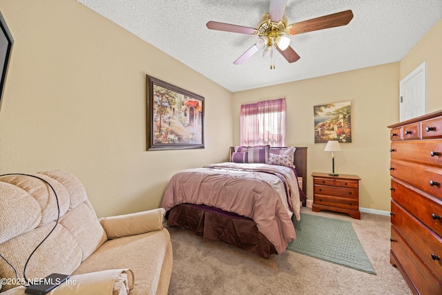 bedroom with a textured ceiling, a ceiling fan, and carpet floors