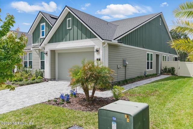 55 Cool Springs Ave, Ponte Vedra, FL 32081 - view of front facade featuring a front yard, roof with shingles, fence, board and batten siding, and decorative driveway