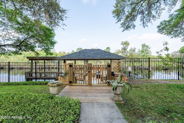 wooden terrace featuring a water view