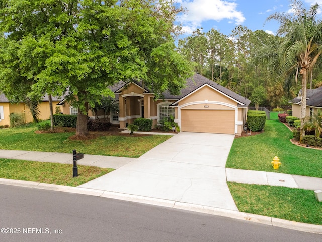 view of front of home featuring driveway, stucco siding, a front lawn, and a garage