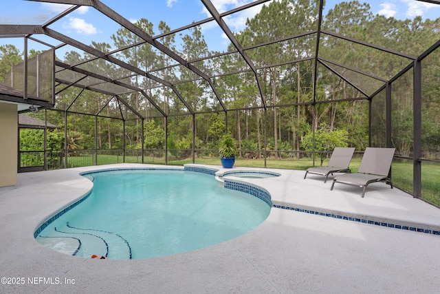 view of swimming pool with a patio, a pool with connected hot tub, and glass enclosure