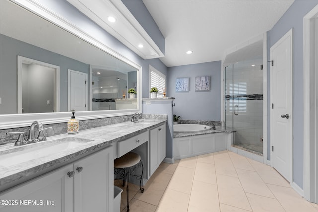 bathroom with a shower stall, a garden tub, double vanity, and a sink