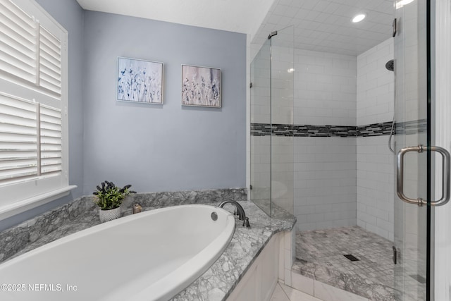 full bathroom featuring a stall shower and a garden tub