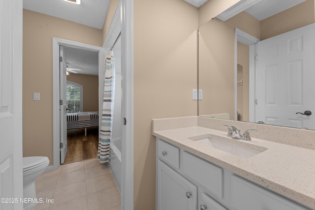 bathroom featuring toilet, tile patterned floors, vanity, and shower / tub combo with curtain
