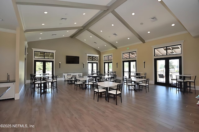 dining space featuring light wood-style floors, high vaulted ceiling, beamed ceiling, visible vents, and french doors