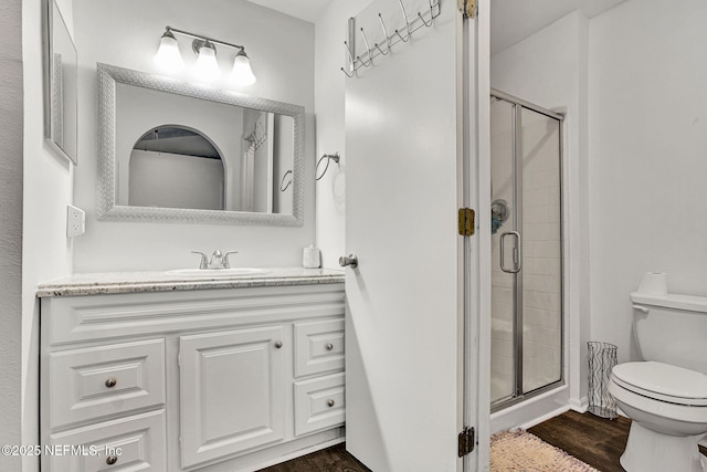 2682 Kimberly Forest Dr E, Jacksonville, FL 32246 - full bath featuring a stall shower, toilet, wood finished floors, and vanity