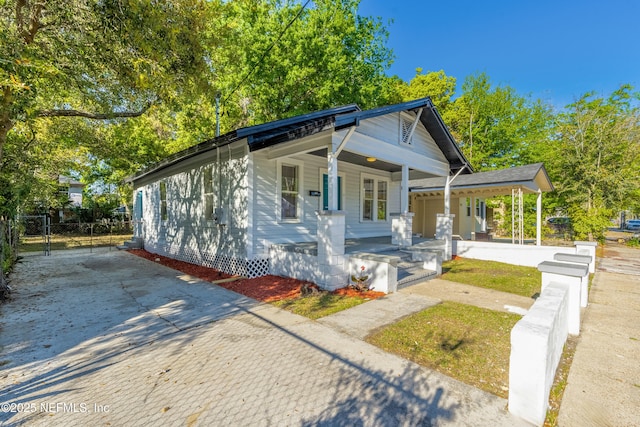 1539 7th St W, Jacksonville, FL 32209 - bungalow featuring driveway, a gate, fence, and a porch