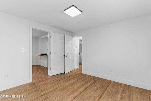 1539 7th St W, Jacksonville, FL 32209 - unfurnished bedroom featuring light wood finished floors and baseboards