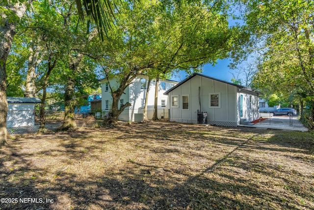 1539 7th St W, Jacksonville, FL 32209 - rear view of house with fence, cooling unit, and board and batten siding