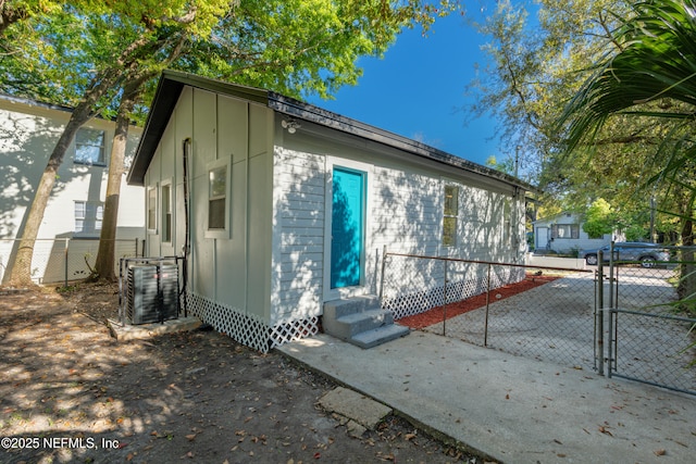 1539 7th St W, Jacksonville, FL 32209 - view of property exterior with cooling unit, fence, entry steps, and a gate