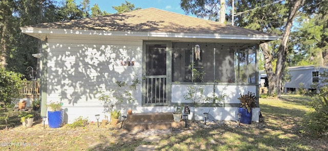 view of outdoor structure featuring a sunroom and entry steps