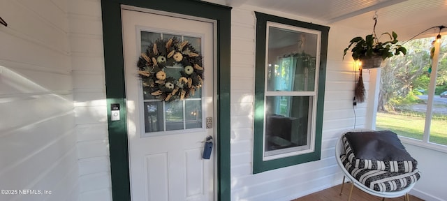 entrance to property featuring covered porch