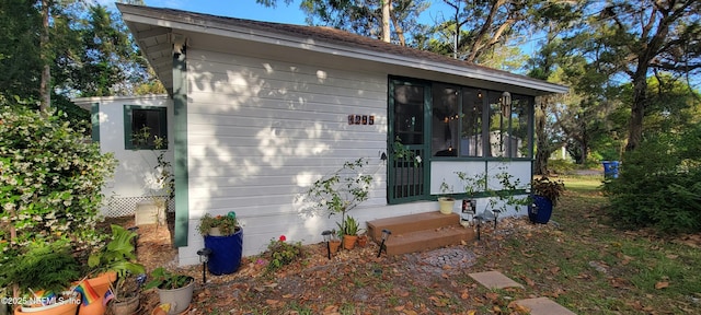 exterior space with entry steps and a sunroom