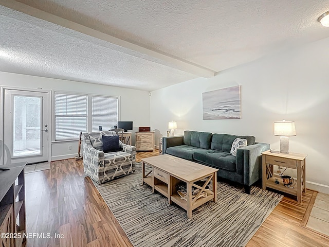 3434 Blanding Blvd Unit 116, Jacksonville, FL 32210 - living area featuring light wood-style flooring, beam ceiling, baseboards, and a textured ceiling