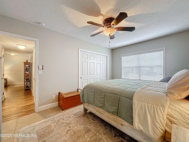 3434 Blanding Blvd Unit 116, Jacksonville, FL 32210 - bedroom featuring a textured ceiling, a closet, baseboards, and light tile patterned floors