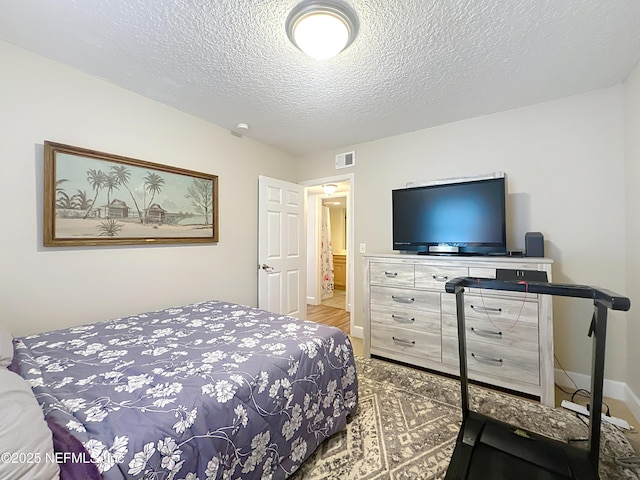 3434 Blanding Blvd Unit 116, Jacksonville, FL 32210 - bedroom with baseboards, a textured ceiling, and visible vents
