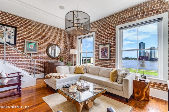 301 E Bay St Unit 405, Jacksonville, FL 32202 - living area featuring brick wall, wood-type flooring, and baseboards