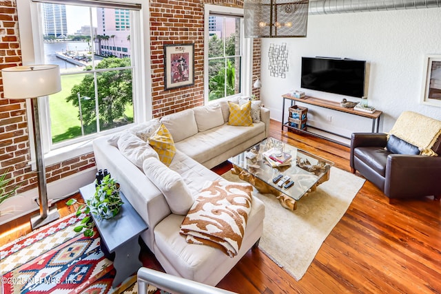301 E Bay St Unit 405, Jacksonville, FL 32202 - living area with brick wall, hardwood / wood-style flooring, and a textured wall