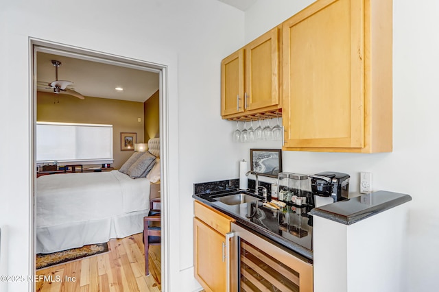 301 E Bay St Unit 405, Jacksonville, FL 32202 - kitchen featuring light wood finished floors, light brown cabinets, beverage cooler, and a sink