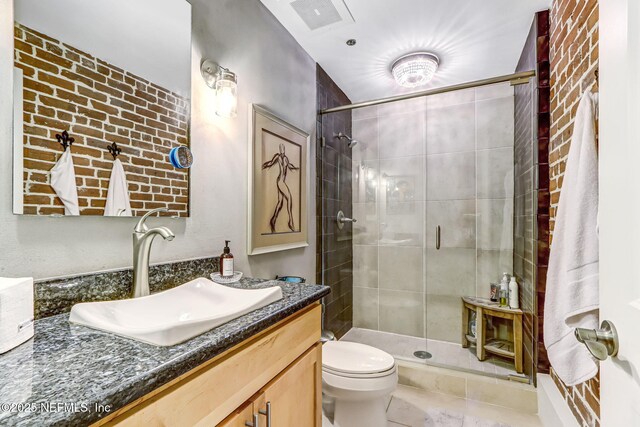 301 E Bay St Unit 405, Jacksonville, FL 32202 - full bath featuring visible vents, toilet, a shower stall, vanity, and tile patterned floors
