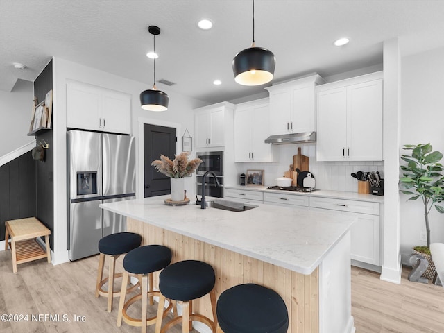 431 Crestview Dr, Ponte Vedra, FL 32081 - kitchen featuring visible vents, light wood-style flooring, appliances with stainless steel finishes, under cabinet range hood, and a sink