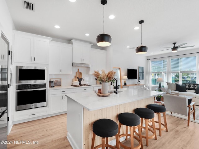 431 Crestview Dr, Ponte Vedra, FL 32081 - kitchen featuring light countertops, open floor plan, under cabinet range hood, stainless steel appliances, and visible vents