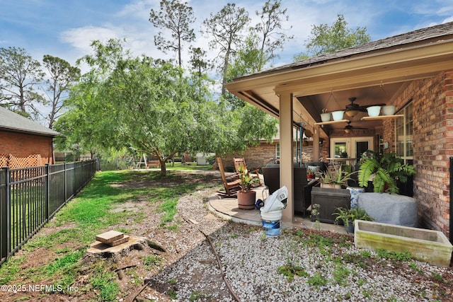 13233 Pecky Cypress Dr, Jacksonville, FL 32223 - view of yard with ceiling fan, a fenced backyard, french doors, and a patio area