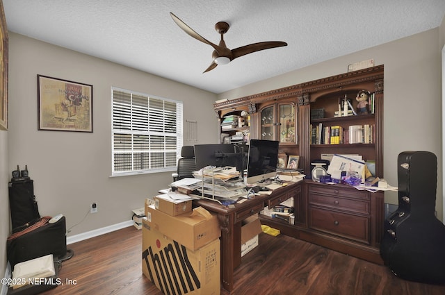 13233 Pecky Cypress Dr, Jacksonville, FL 32223 - office featuring a textured ceiling, a ceiling fan, baseboards, and dark wood-style flooring