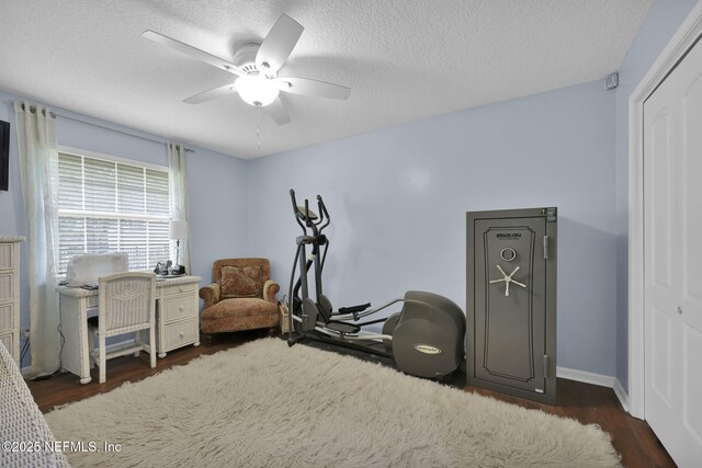 13233 Pecky Cypress Dr, Jacksonville, FL 32223 - workout room featuring ceiling fan, baseboards, wood finished floors, and a textured ceiling
