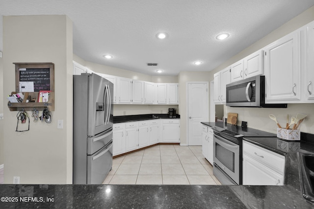 13233 Pecky Cypress Dr, Jacksonville, FL 32223 - kitchen with visible vents, appliances with stainless steel finishes, white cabinetry, and light tile patterned floors