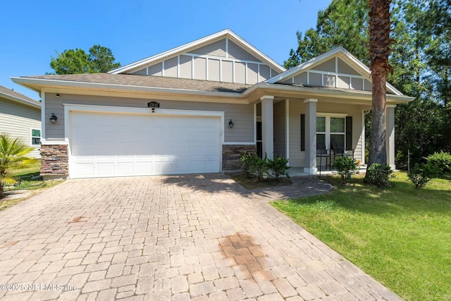 15943 Baxter Creek Dr, Jacksonville, FL 32218 - craftsman house with driveway, an attached garage, board and batten siding, a front lawn, and a porch
