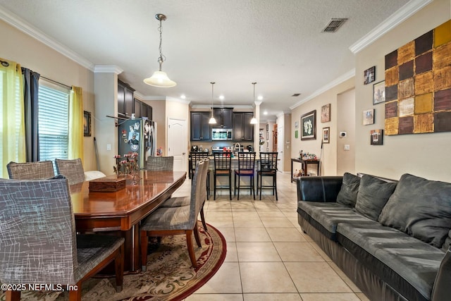 15943 Baxter Creek Dr, Jacksonville, FL 32218 - dining area with a textured ceiling, ornamental molding, visible vents, and light tile patterned floors