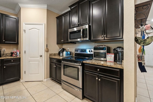15943 Baxter Creek Dr, Jacksonville, FL 32218 - kitchen featuring ornamental molding, stainless steel appliances, dark cabinets, and light stone counters