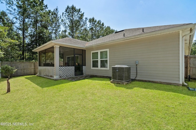 15943 Baxter Creek Dr, Jacksonville, FL 32218 - back of property with a fenced backyard, a sunroom, central air condition unit, and a yard