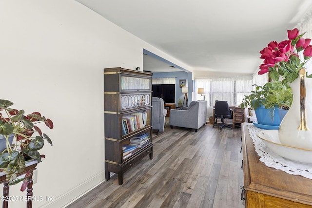 corridor featuring hardwood / wood-style flooring and baseboards