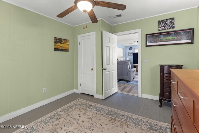 bedroom featuring ceiling fan, baseboards, dark wood finished floors, and visible vents