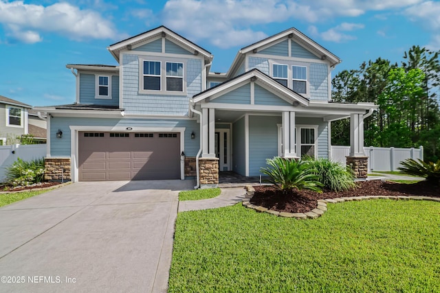 185 Calumet Dr, Saint Johns, FL 32259 - craftsman-style house with concrete driveway, fence, a front lawn, covered porch, and a garage