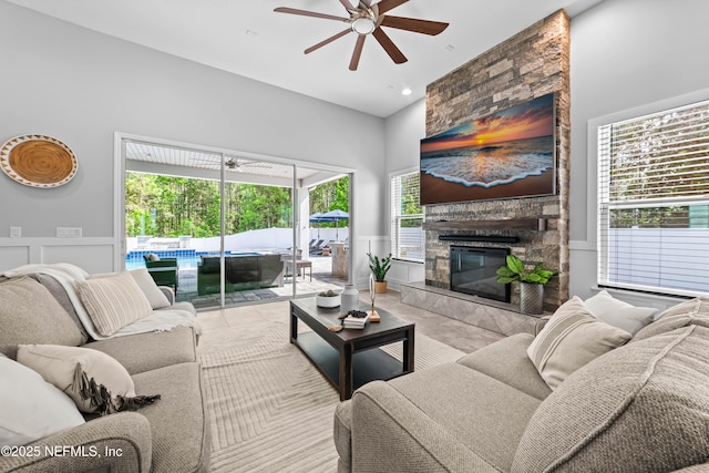 185 Calumet Dr, Saint Johns, FL 32259 - living area featuring a wainscoted wall, a fireplace, a decorative wall, and a ceiling fan