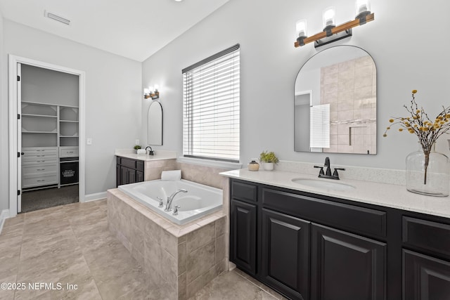 185 Calumet Dr, Saint Johns, FL 32259 - full bath featuring a walk in closet, a sink, visible vents, two vanities, and a bath