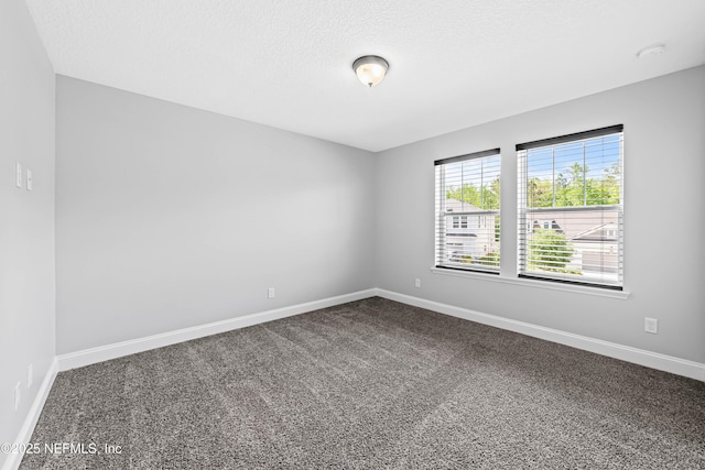 185 Calumet Dr, Saint Johns, FL 32259 - unfurnished room featuring dark carpet, baseboards, and a textured ceiling