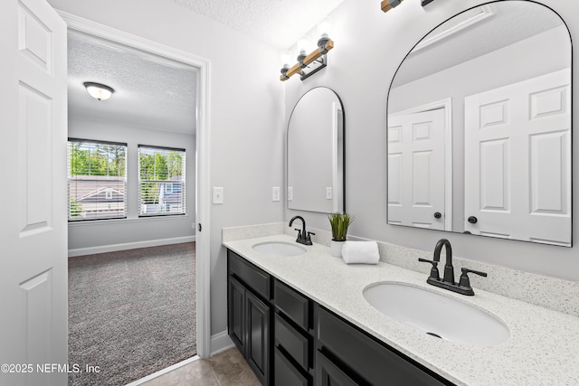 185 Calumet Dr, Saint Johns, FL 32259 - full bathroom with baseboards, double vanity, a textured ceiling, and a sink