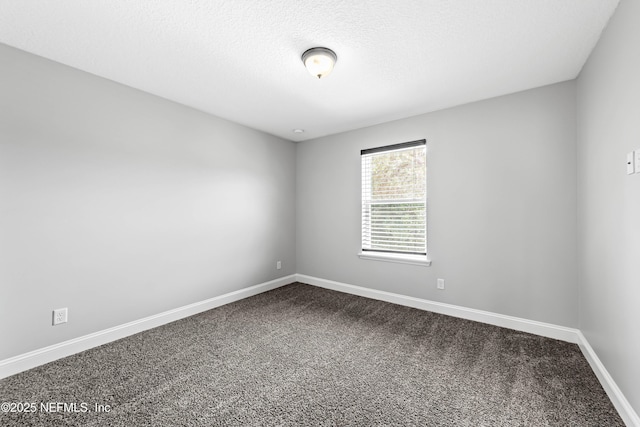 185 Calumet Dr, Saint Johns, FL 32259 - empty room featuring baseboards, dark carpet, and a textured ceiling