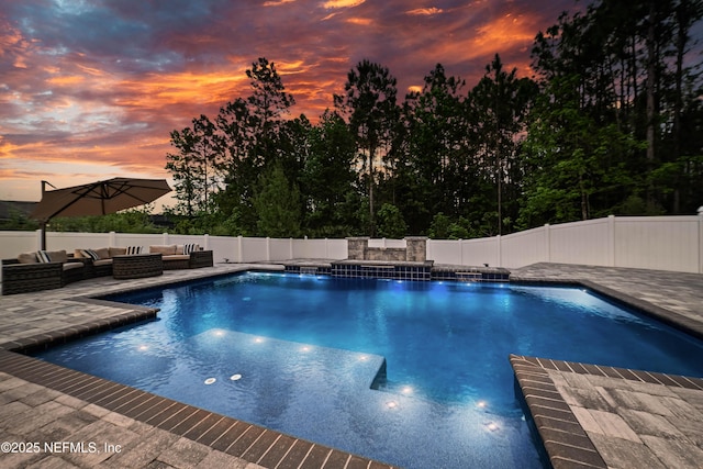 185 Calumet Dr, Saint Johns, FL 32259 - pool at dusk with a fenced backyard, an outdoor hangout area, a patio area, and a fenced in pool